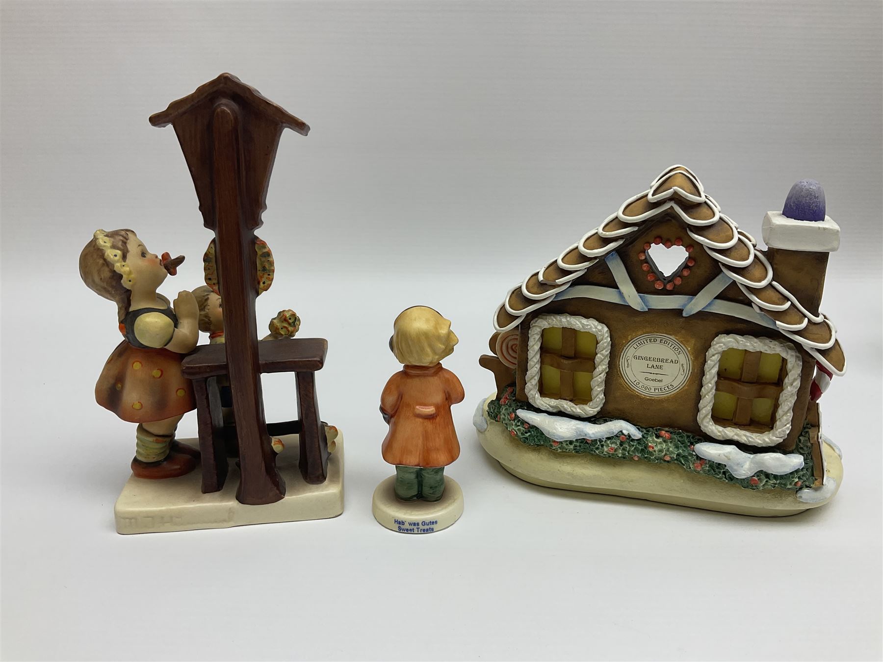 Eight Christmas Hummel figures by Goebel, to include Wintertime Chapel candle holder, Winter Fun, Christmas Morning, Christmas Time and Gingerbread Lane, tallest H21cm