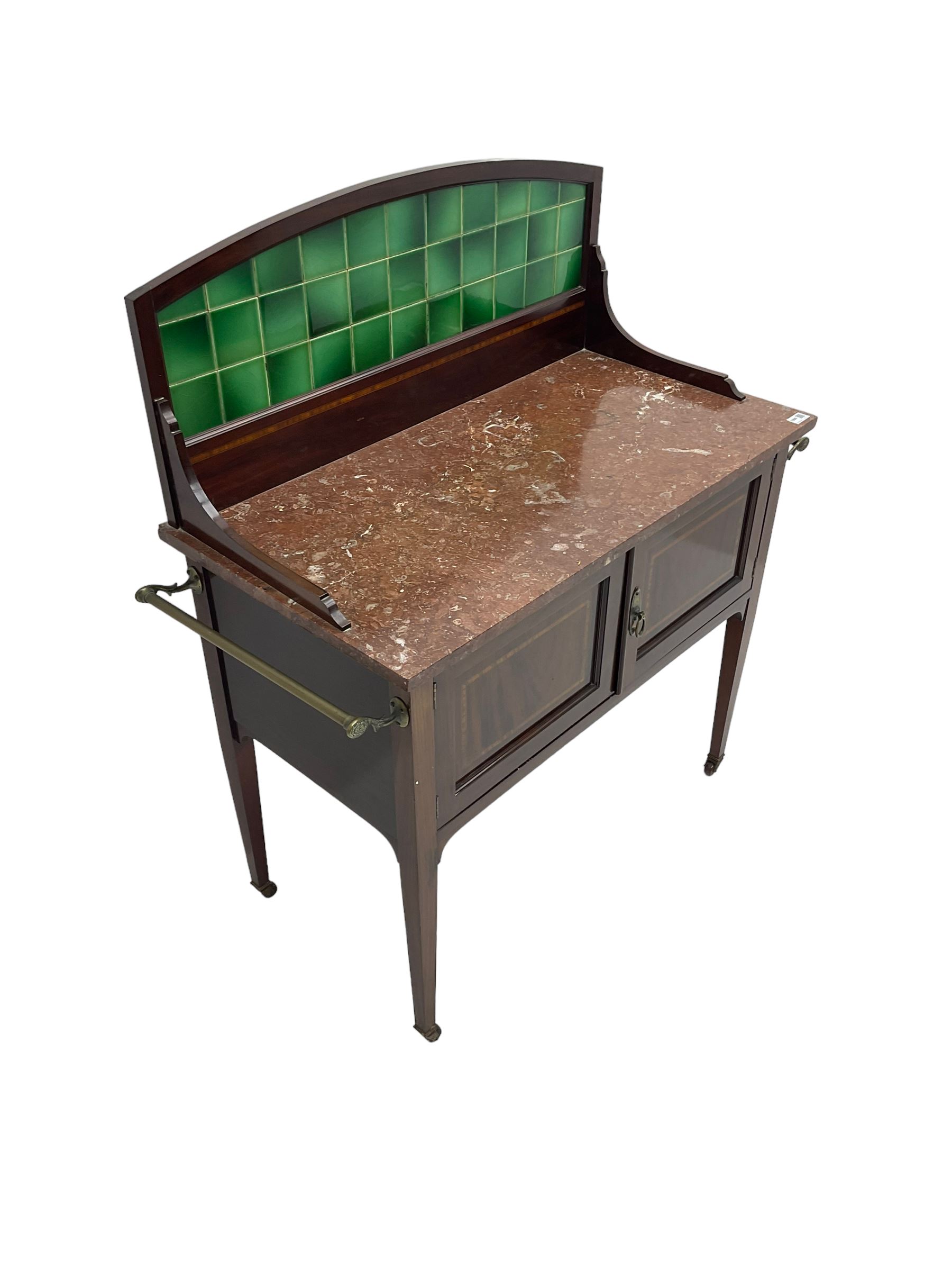 Edwardian inlaid mahogany washstand, raised back with emerald green tiles over marble top, fitted with two panelled cupboard doors, raised on square tapering supports on ceramic castors