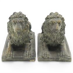 Pair of bronze-effect composition stone recumbent lions, with verdigris-style weathered finish, each raised on rectangular plinth base