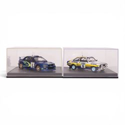 Four Troufeu 1:43 scale diecast model rally cars, including two limited edition Subaru's commemorating wins by Richard Burns, a Ford Escort RD 2000 and a Ford Escort Mk II, all in acrylic display cases