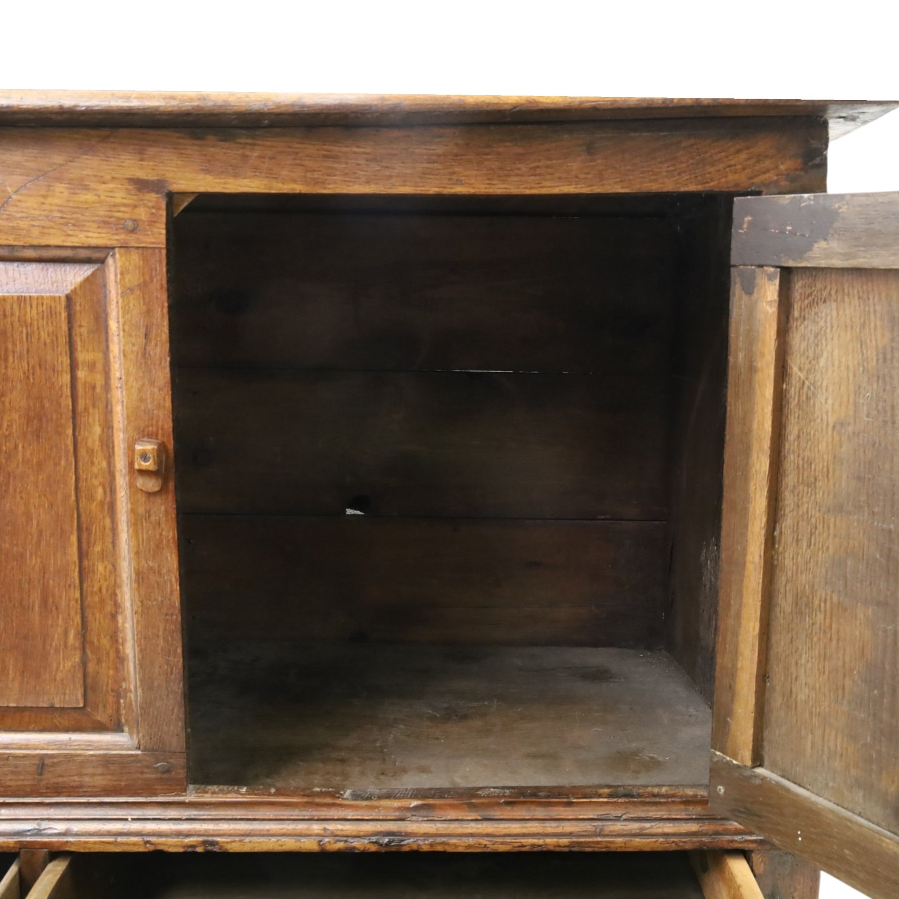 18th century oak hall cupboard, rectangular top with moulded edge, over two panelled hutch-cupboards, the base fitted with six assorted drawers, on large bracket feet