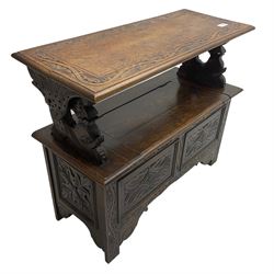 Early 20th century carved oak monk's bench, hinged moulded top carved with lunettes on dolphin supports, hinged box seat, the panelled front carved with foliate lozenges