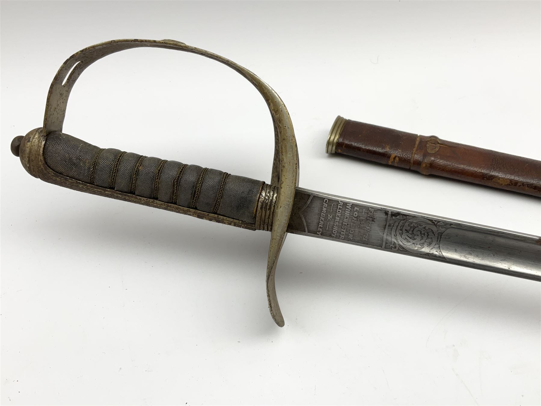 George V 1897 pattern army officer's sword the 82.5cm etched blade by Flights Ltd London, Winchester, Aldershot & Camberley, nickel plated pierced hilt and wire bound fish-skin grip, in leather scabbard, L101cm overall
