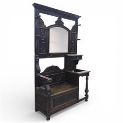 Victorian heavily carved oak hall-stand, central bevelled mirror with four coat pegs, abov...