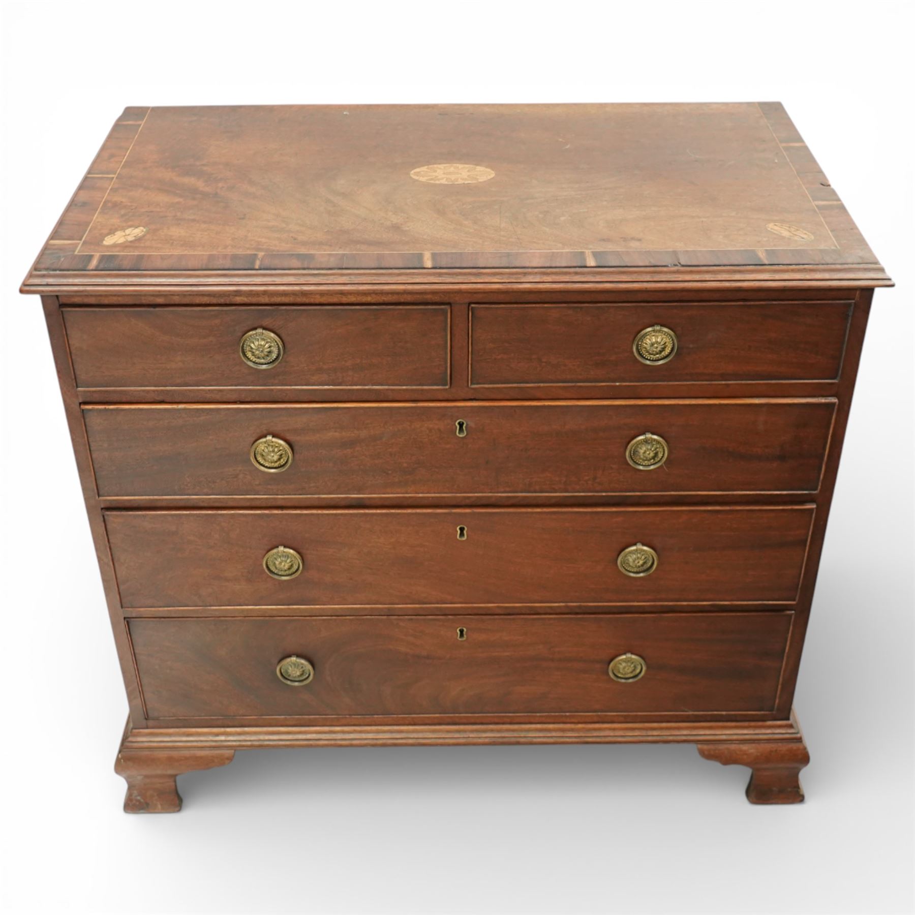 George III crossbanded mahogany chest, rectangular top with crossbanded edge and oval satinwood medallion, two short over three long graduated drawers with brass swan neck handles, raised on shaped bracket feet