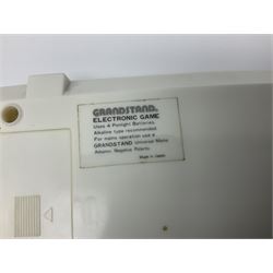 Three late 70s/early 80s handheld electronic games; Bandai Electronics Arcade ‘Gunfighter’ (1980), Grandstand ‘Invader From Space’ (1980), Palitoy ‘Merlin The Electronic Game Machine’ (1979) with game sheet and instruction booklet, all with original boxes (3) 