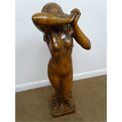  Large carved figured oak model of a diaphanously draped young woman, she stands barefoot with hands clasped above bowed head, on naturalistic square base with tree stump, H120cm, W37cm, D30cm   