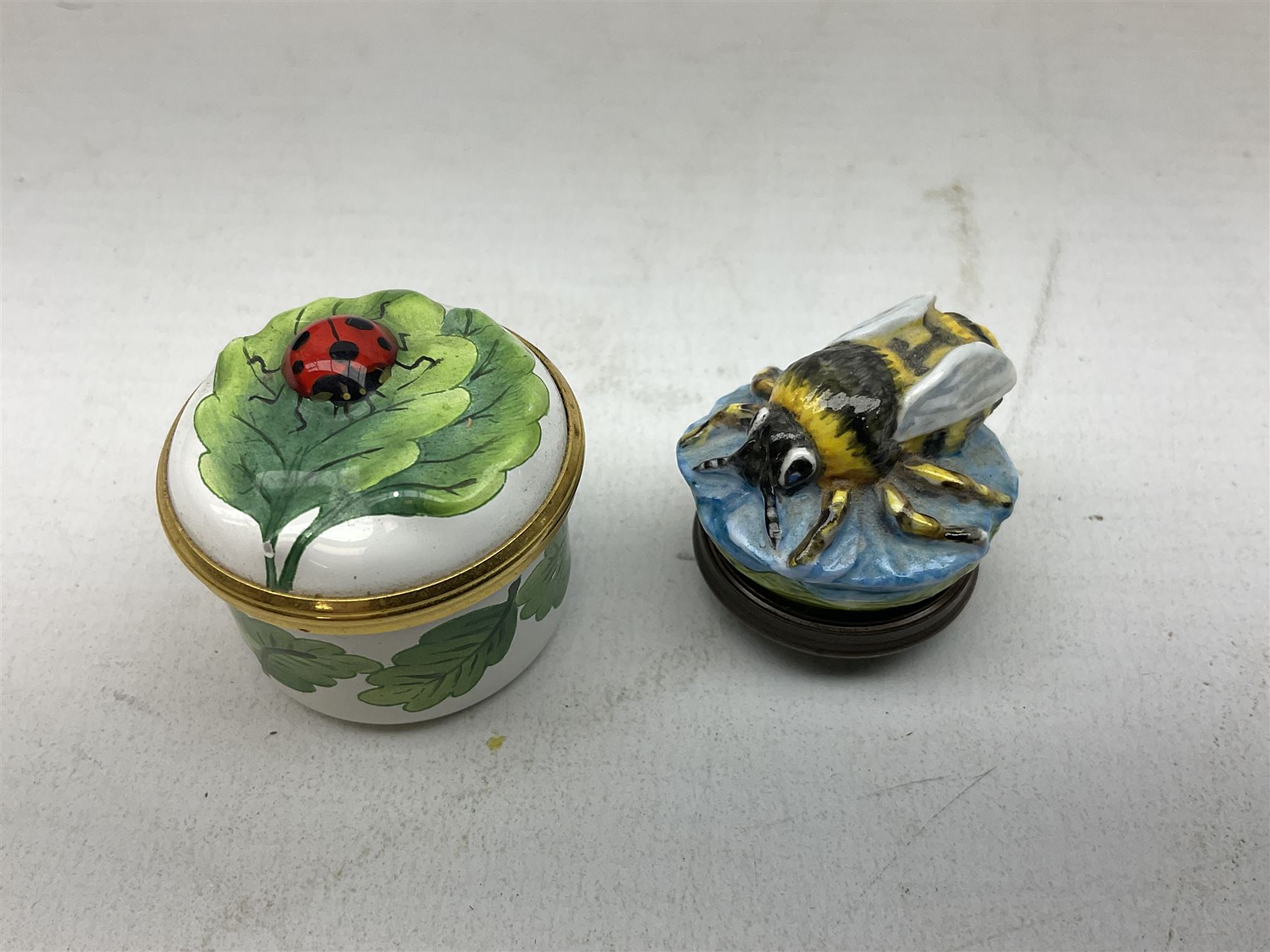 Two Halcyon Days enamel bonbonnieres modelled as mice, I am a magical mouse, and ''Consider the little mouse, how sagacious an animal it is...' Roman Playwright', together with three Halcyon Days enamel boxes, modelled as a bee upon a flower, a ladybird upon a leaf, and a strawberry, each in fitted box, (5)