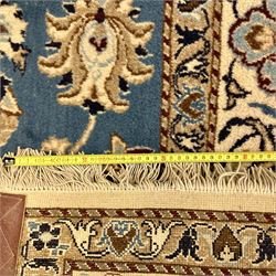 Central Persian Kashan rug, densely knotted, in a teal and cream ground, central medallion with circular rosette surrounded by a highly detailed field of radiating palmettes, vine arabesque patterns, rosettes, and  lotus blossoms, main border with alternating palmettes flanked by two narrower guard borders with a repeating floral meander design 