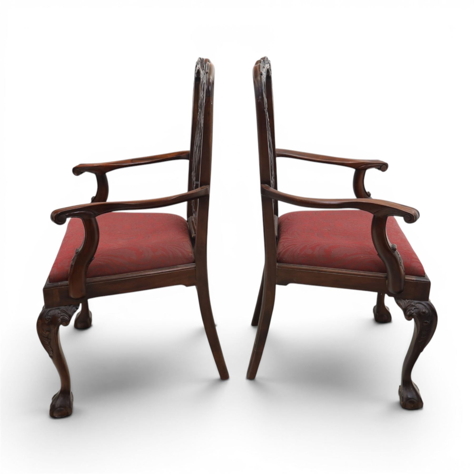 Chippendale design set of ten (8+2) mahogany dining chairs, serpentine cresting rails with carved detail over pierced ribbon-tied splats, red damask upholstered drop-in seats, on cabriole supports with acanthus carved knees and claw and ball feet