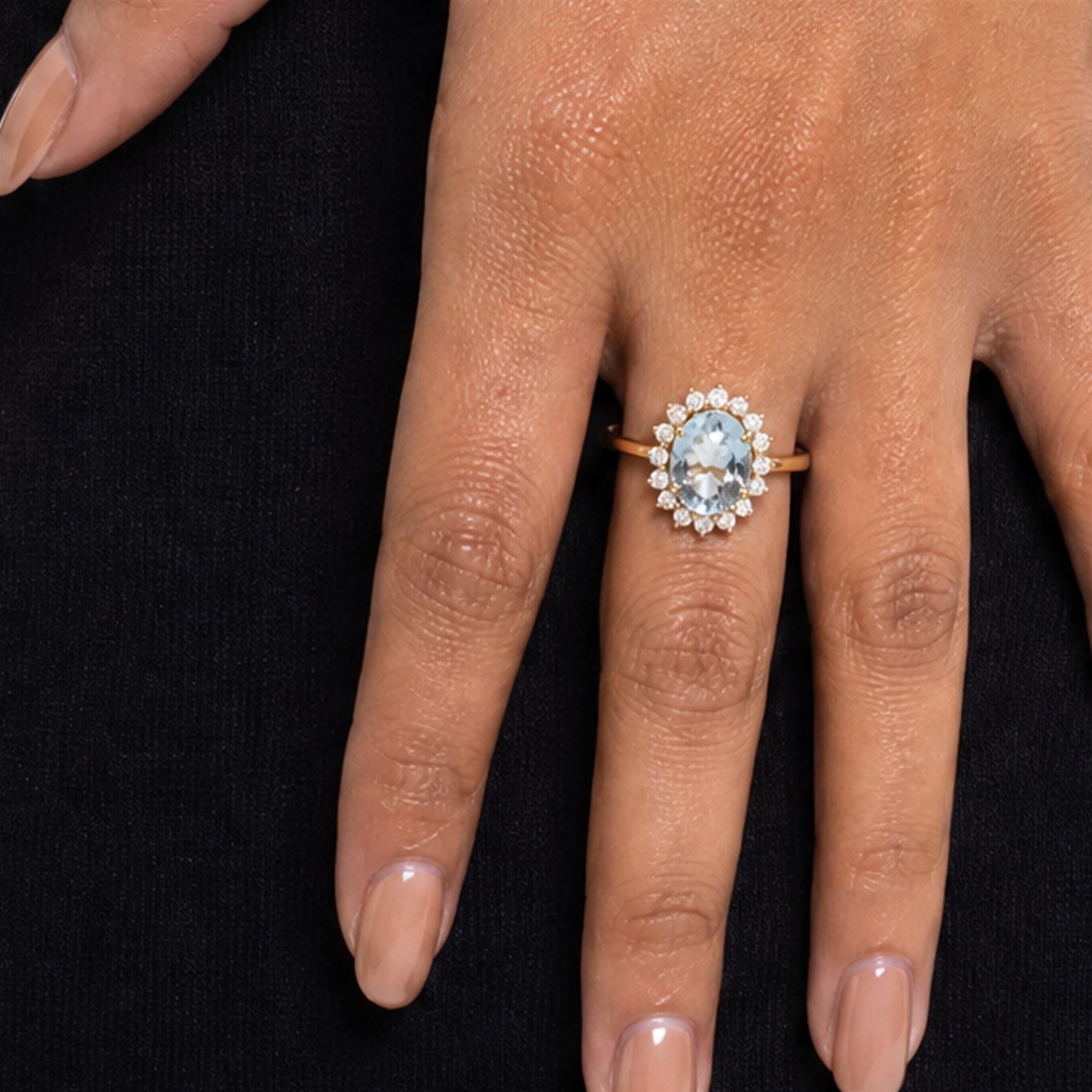 18ct gold aquamarine and diamond cluster ring, single oval cut aquamarine of approx 2.05 carat, surrounded by sixteen round brilliant cut diamonds, stamped, total diamond weight 0.40 carat