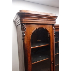  William IV rosewood breakfront bookcase, moulded cornice with scroll carved corbels above five glazed doors with adjustable shelves, on a plinth base, W285cm, H190cm, D52cm  