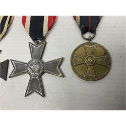 Two WW1 German medals - copy Cross of Honour with swords (combatants); Cross of Honour without swords (non-combatants); and two WW2 German medals - War Merit Medal; and War Merit Cross; all with ribbons (4)
