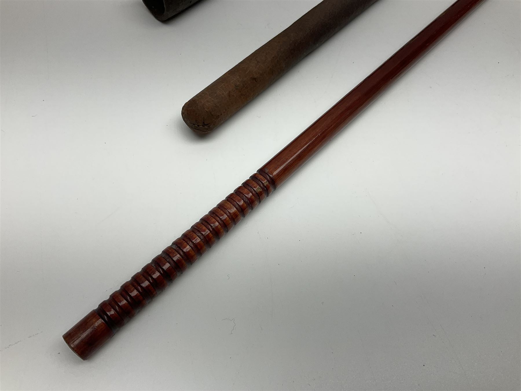 19th century continental folding knife with 15.5cm single edged blade, the pierced brass and iron handle with remains of horn grips L21.5cm overall closed; turned horn handled knife with foliate engraved blade; battlefield relic German 1884/98 knife bayonet; iron spear head; leather covered swagger stick; and two-piece gun cleaning rod