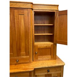 Large contemporary cherry wood break-front wall unit, the banded cornice over double cupboard with bifold doors and two drawers, flanked by four single cupboards, the base fitted with four drawers over four cupboards