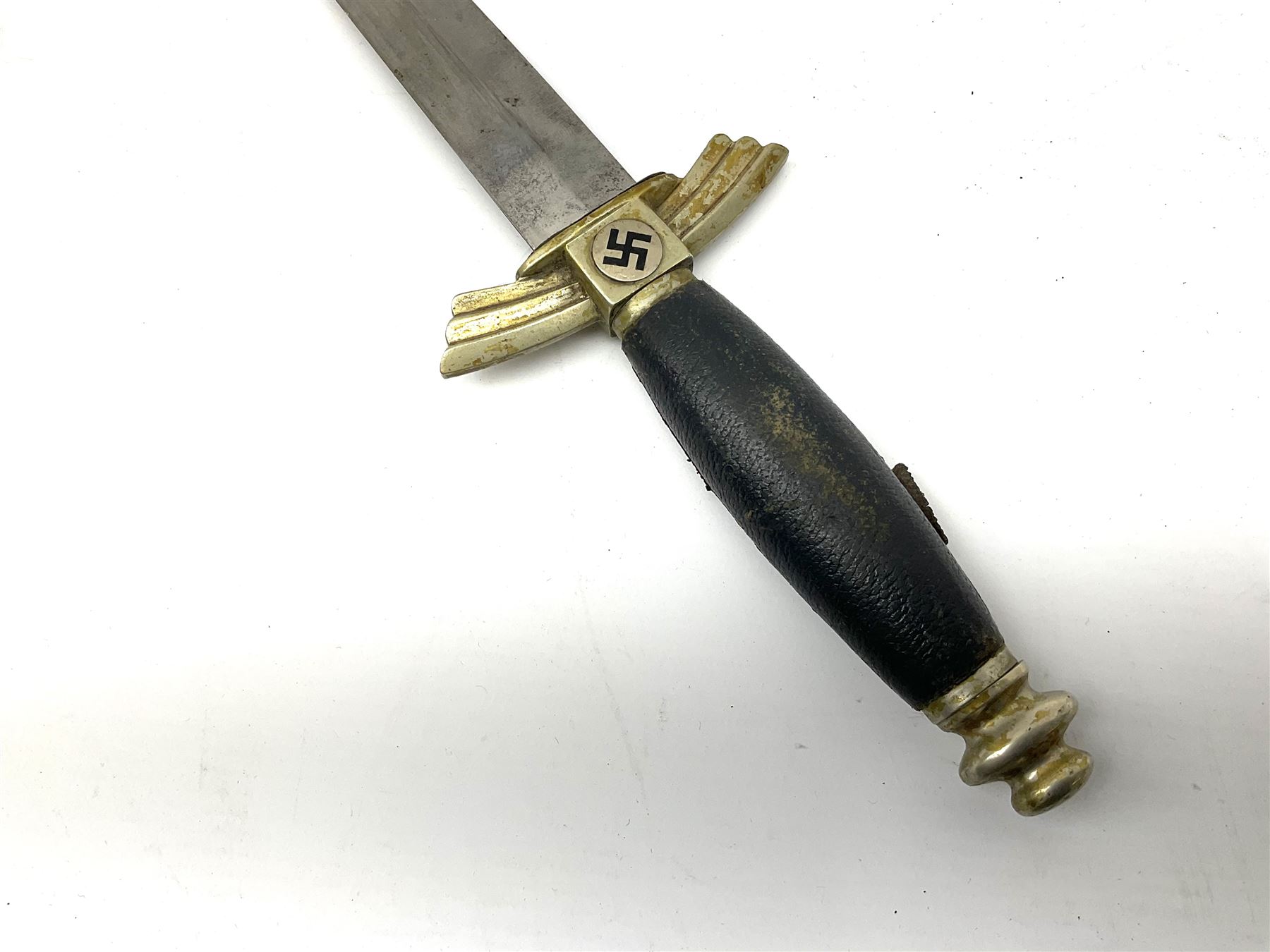  WW2 German SMF Solingen DLV flyers dagger with 16cm steel blade, nickel downswept cross-piece and pommel and leather covered grip, in leather and nickel scabbard with leather suspension strap L34cm overall. After WWI Germany was forbidden an air force by the Treaty of Versailles however the Deutscher Luftsport-Verband (German Air-sport Association) was formed in March 1933 from various sports flying clubs and had branches for aeroplane, gliding and balloon flying. Under cover of the sporting DLV, many future Luftwaffe pilots trained to fly. DLV was embodied with the NSKK in March 1935 and 1st March 1937 Luftwaffe formed.