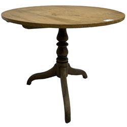 Early 19th century pine and elm tripod table; circular tilt-top over turned column and three splayed supports