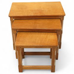 Mouseman - nest of three oak occasional tables, rectangular adzed top, on octagonal supports united by plain stretchers, each carved with mouse signature, by the workshop of Robert Thompson, Kilburn