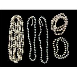 Four fresh water pearl necklaces, including a long two tone example, and a fresh water pearl three row bracelet
