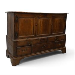 18th century oak hall cupboard, rectangular top with moulded edge, over two panelled hutch-cupboards, the base fitted with six assorted drawers, on large bracket feet