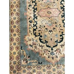 Persian design rug, pale ground with overall foliate design, the border decorated with stylised motifs 