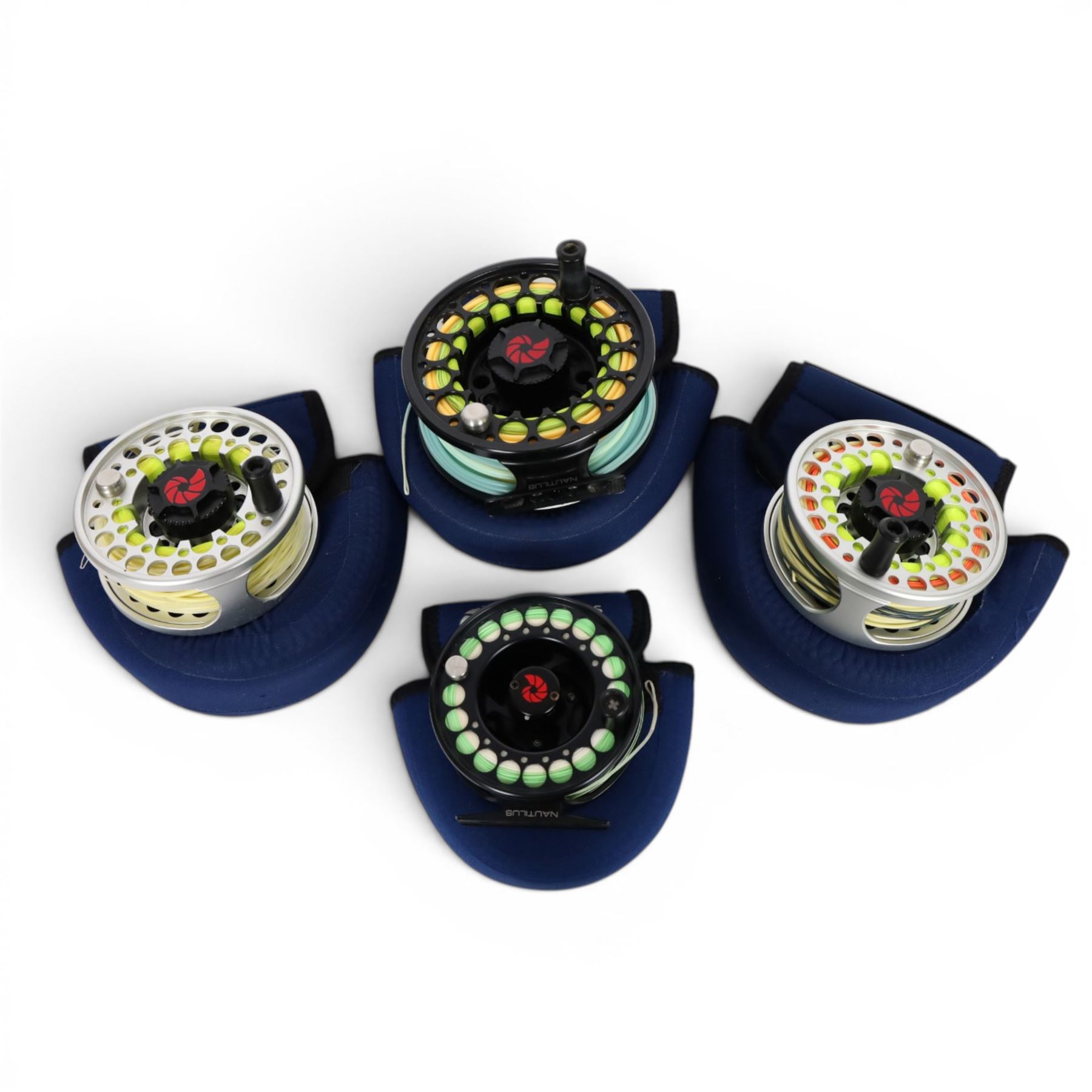Four Nautilus USA fly reels, comprising T12, no. five and two no. ten models, all within Nautilus pouches