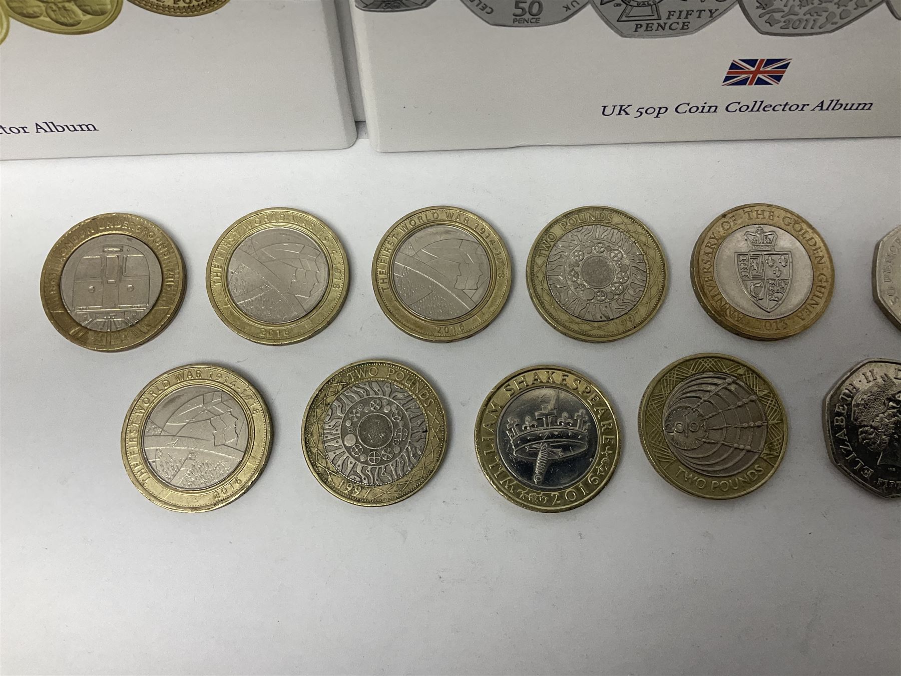 The Royal Mint United Kingdom mostly commemorative two pound, old round one pound and fifty pence coins, overall face value approximately 110 GBP, housed in three 'Coin Hunt' folders and loose