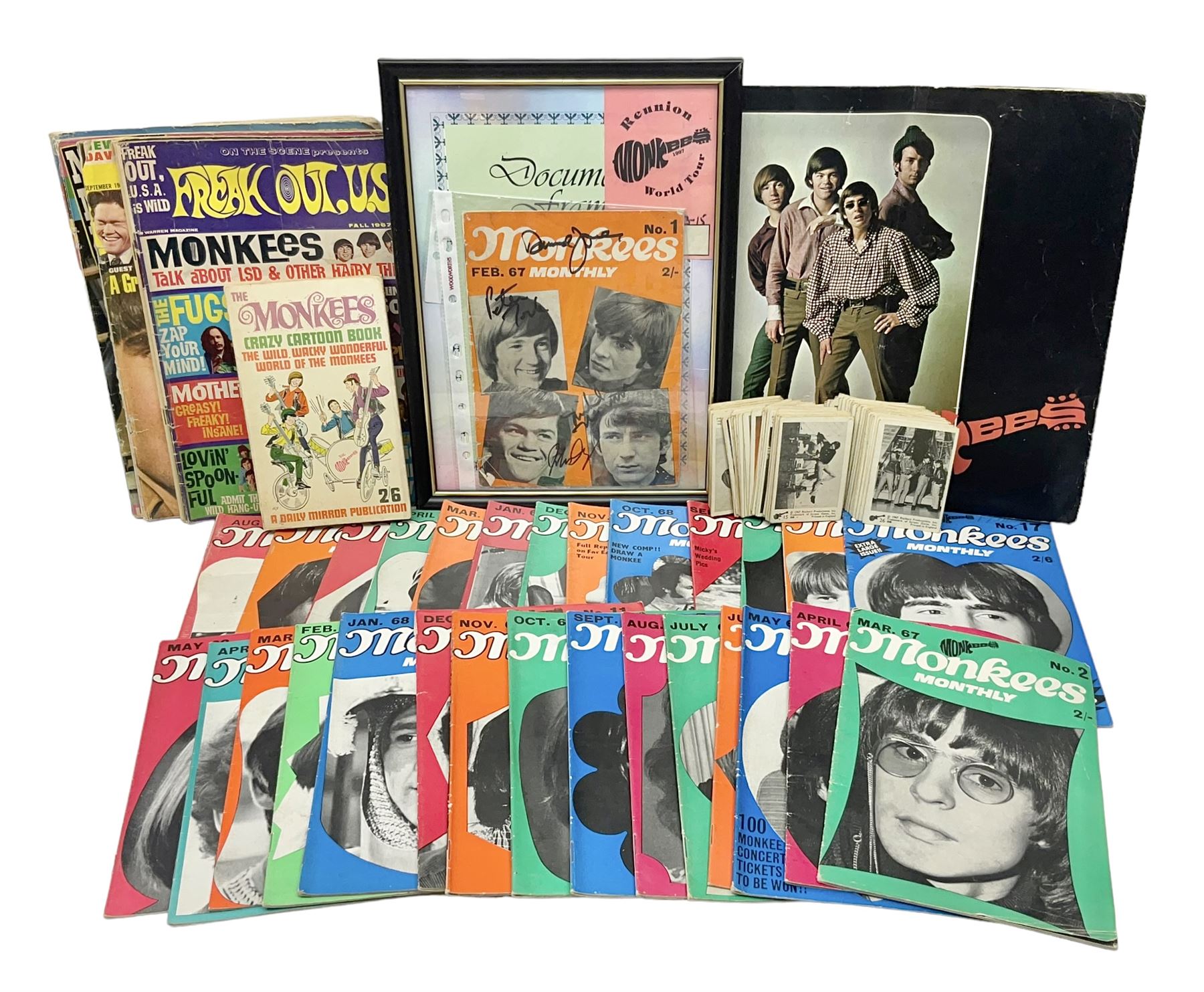 Monkees memorabilia - 'Monkees Monthly' magazine almost complete run from No.1 Feb 67 to No.31 Aug 69 (lacking nos.29 and 32); the cover of No.1 signed by all four members of the group during their 1997 Reunion Tour; quantity of A&BC bubble gum cards; programme for their only UK live performance in 1967 at Empire Pool Wembley; and other related late 1960s music magazines/paperback book