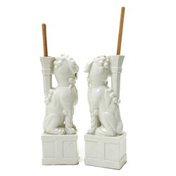 Pair of 19th century Chinese blanc de chine joss stick holders in the form of  Buddhist lions on rectangular bases H20cm (2)