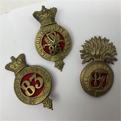 Fifteen cap badges of Irish interest including 4th Royal Irish Dragoon Guards, Connaught Rangers, Royal Irish, Munster and Dublin Fusiliers, 5th Lancers, Inniskilling Regt.,Leinster Regt., Irish Guards etc (15)