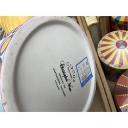 Collection of circus and fairground collectables, to include teapots, biscuit tins, including musical examples, and four Circus/fair themed books, including two library first editions