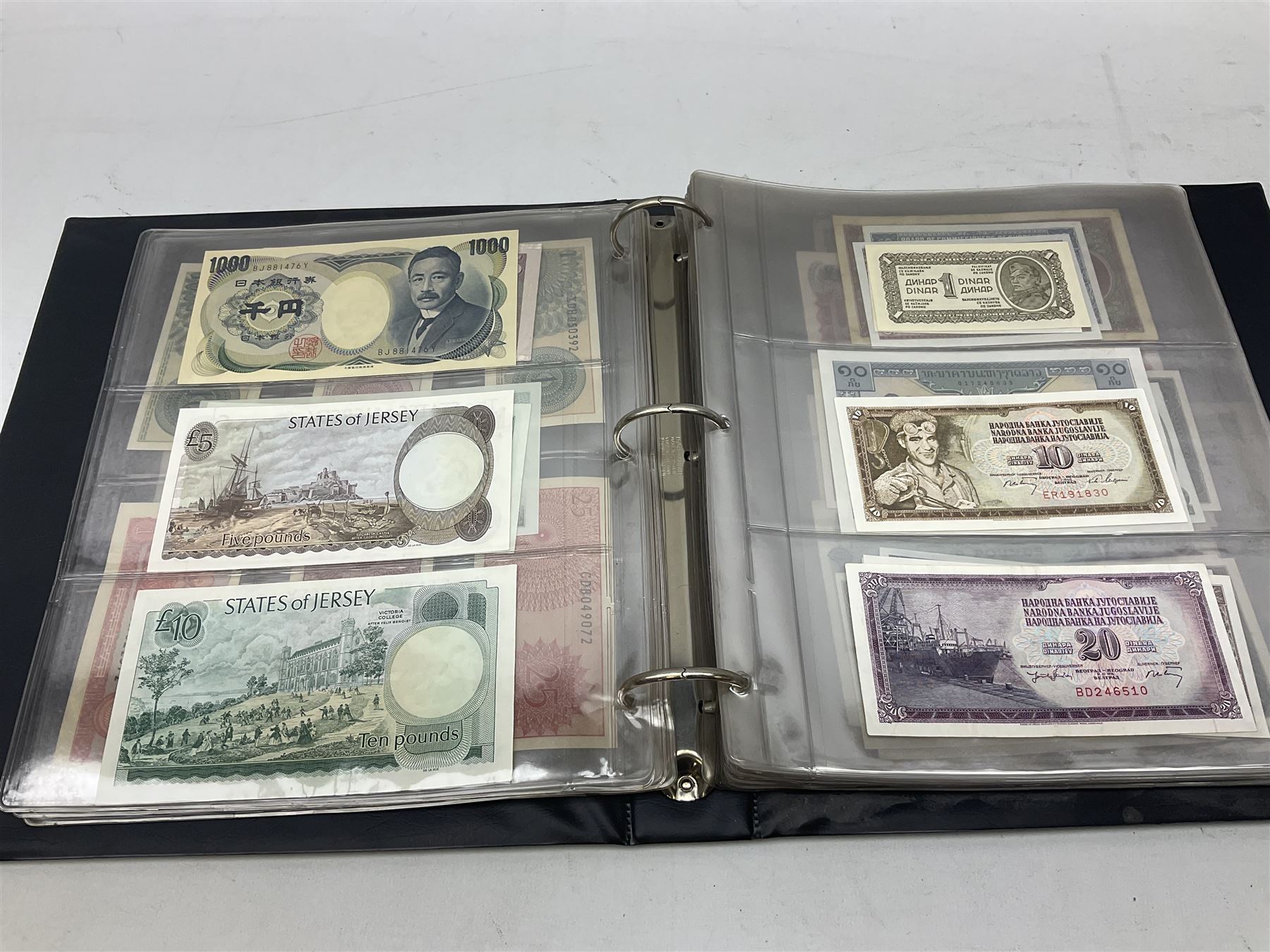 World banknotes, including Queen Elizabeth II The States of Jersey one pound 'DB202703', five pounds 'BB527762' and ten pounds 'AB651481', reserve bank of New Zealand two dollars '1L3 741894', King George V Straits Settlements one dollar 1st January 1935 'F/83 28924', various Bank of England notes etc, housed in two ring binder albums