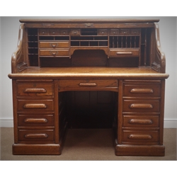  Large late 19th century oak twin pedestal tambour roll top desk, interior fitted with various drawers, correspondence trays and pigeon holes, hinged sides, two slides, nine drawers, plinth base, escutcheon stamped 'Derby Desk, Boston Mass. USA', W155cm, H135cm, D97cm  