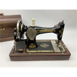 Cased early 20th century Singer hand sewing machine, lacking key