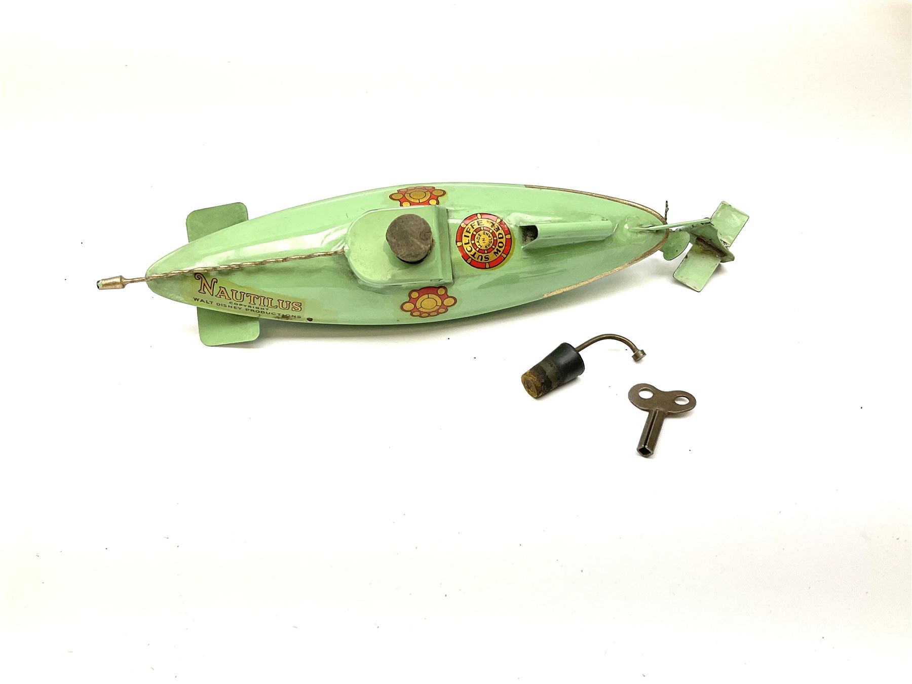 Sutcliffe Models ‘Nautilus’ tinplate and clockwork submarine from Walt Disney’s ’20,000 Leagues Under The Sea’ by Jules Verne, sea green body with various decals, rubber bung with periscope, boxed with inner cardboard display piece, produced between 1955-1960