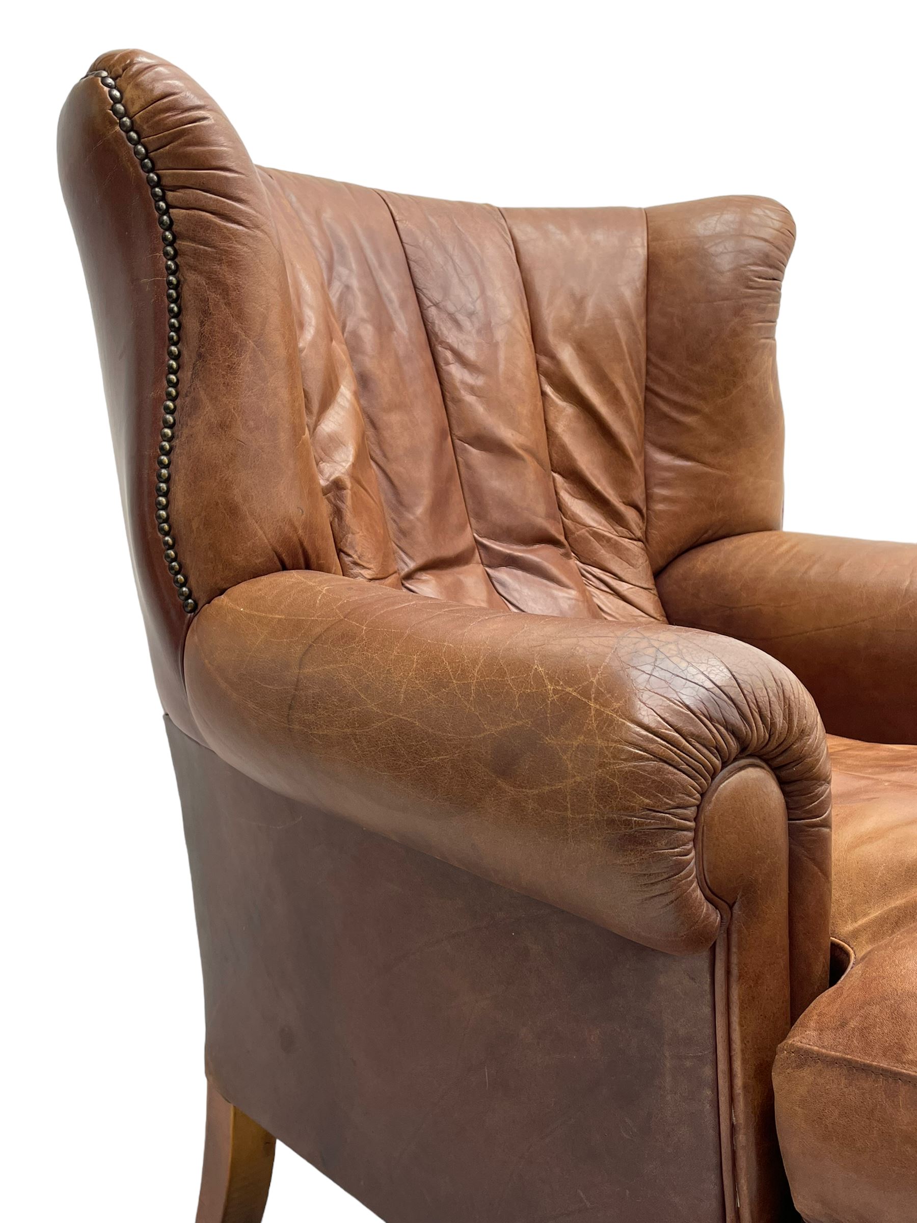Tetrad - 'Blake' club armchair, fanned wingback and rolled arms upholstered in tan brown leather, on ball and claw carved cabriole feet 