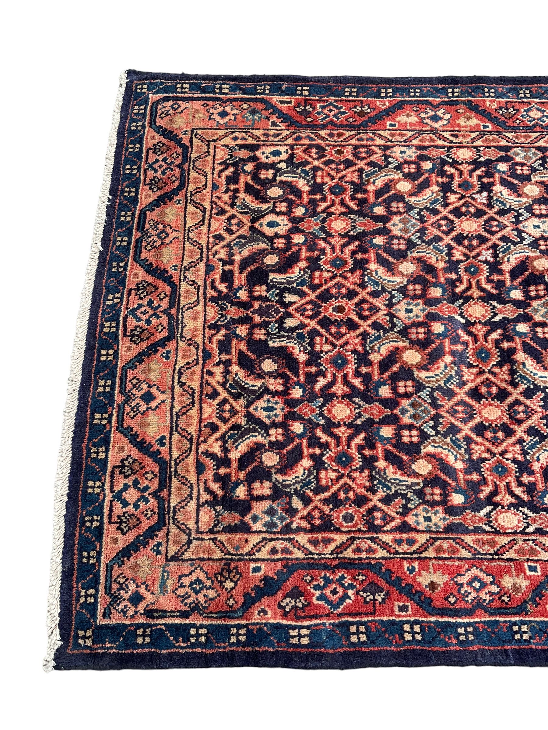 North West Persian Mahal indigo ground runner rug, the field decorated with all-over crimson Herati motifs, the guarded border with trailing geometric designs