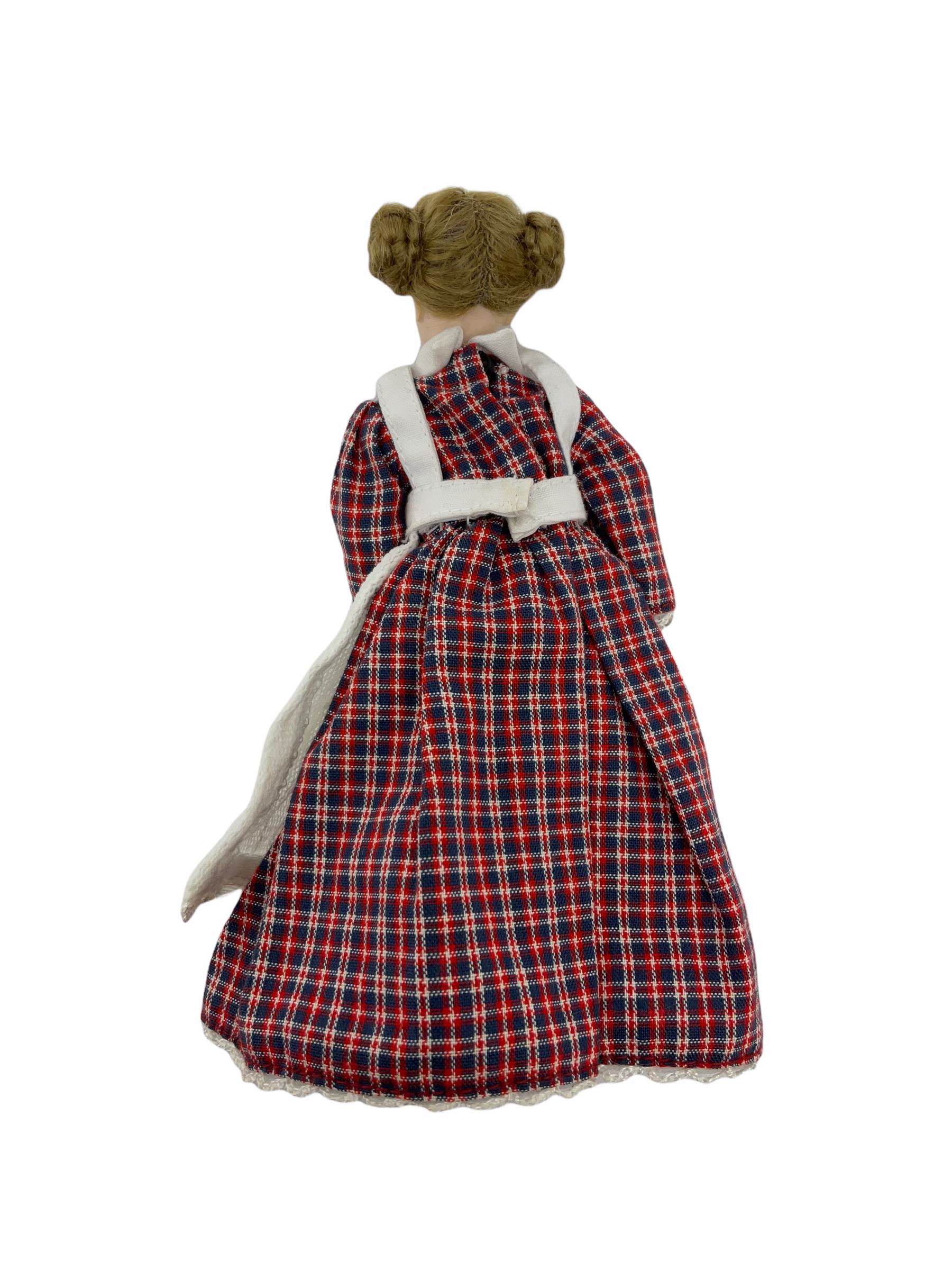 Heidi Ott doll in tartan dress, navy floral dress with white lace and ribbon detailing, striped blue and white dress and a 'Head to Toe' book