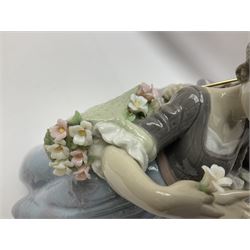 Lladro figure, Southern Charm, modelled as two young ladies one holding a parasol, the other with a basket of flowers on a mahogany wooden base, with original box, no 5700, year issued 1990, year retired 1997, H27cm