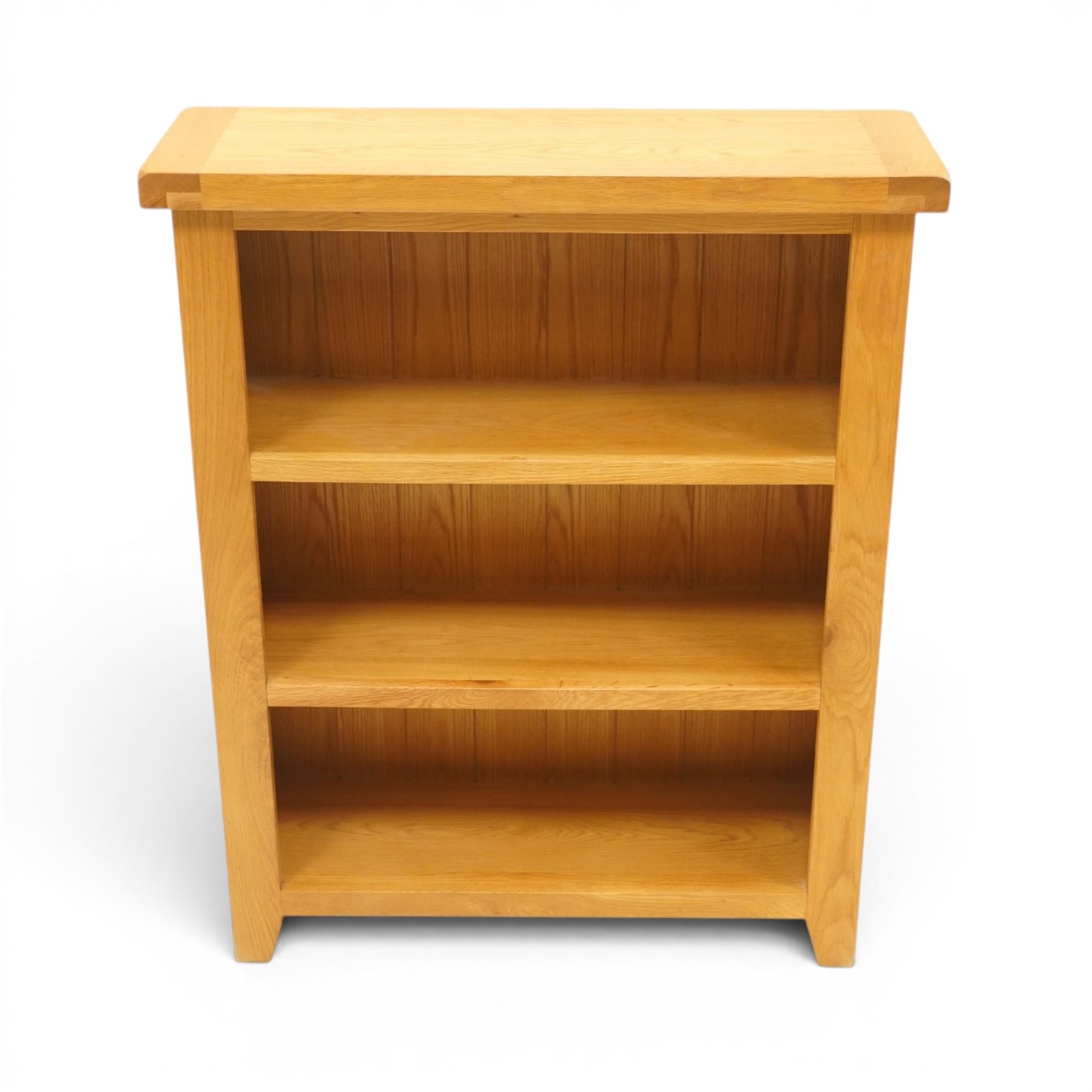 Contemporary solid oak open bookcase, rectangular top over three shelves, on chamfered square feet