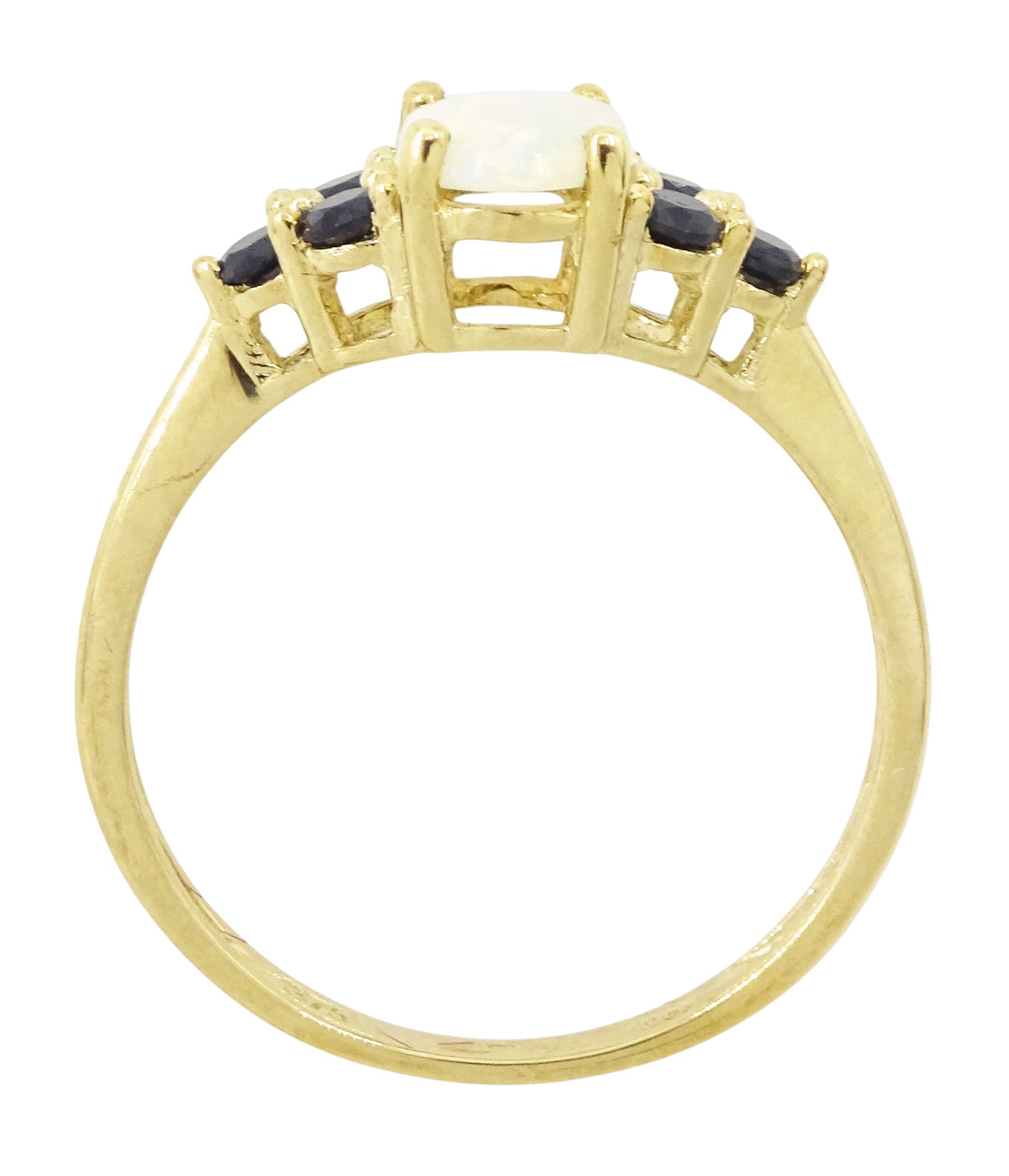 9ct gold opal and sapphire ring, single oval cut opal, with three sapphires set either side, hallmarked