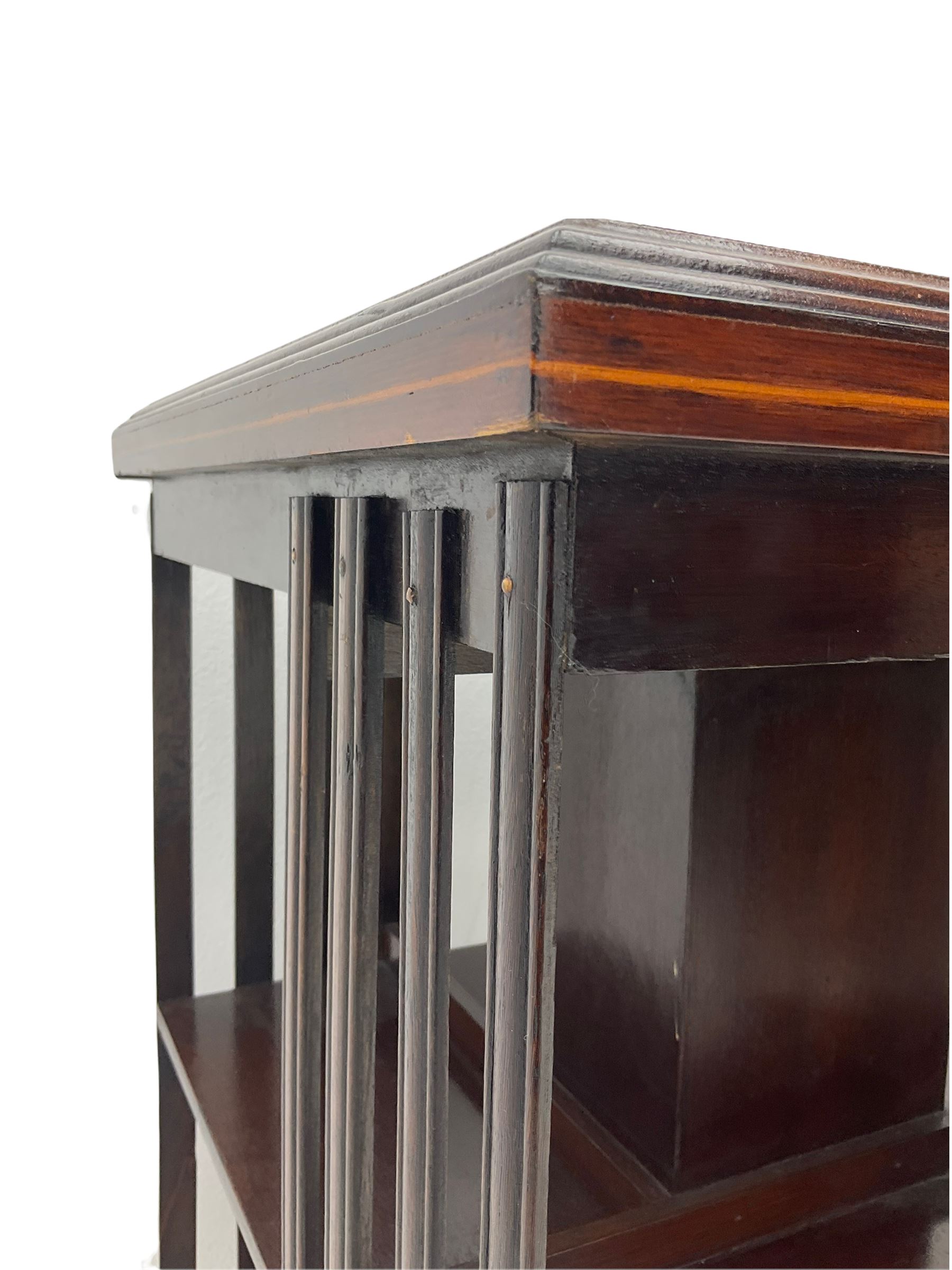 20th century mahogany revolving bookcase, inlaid centre motif, satinwood banded border