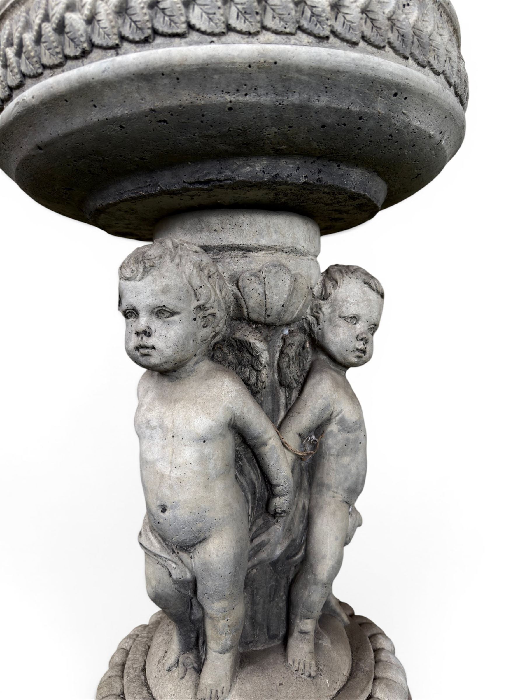 Cast stone cherub bird bath, circular removable top raised on three cherubs with ornate detailing