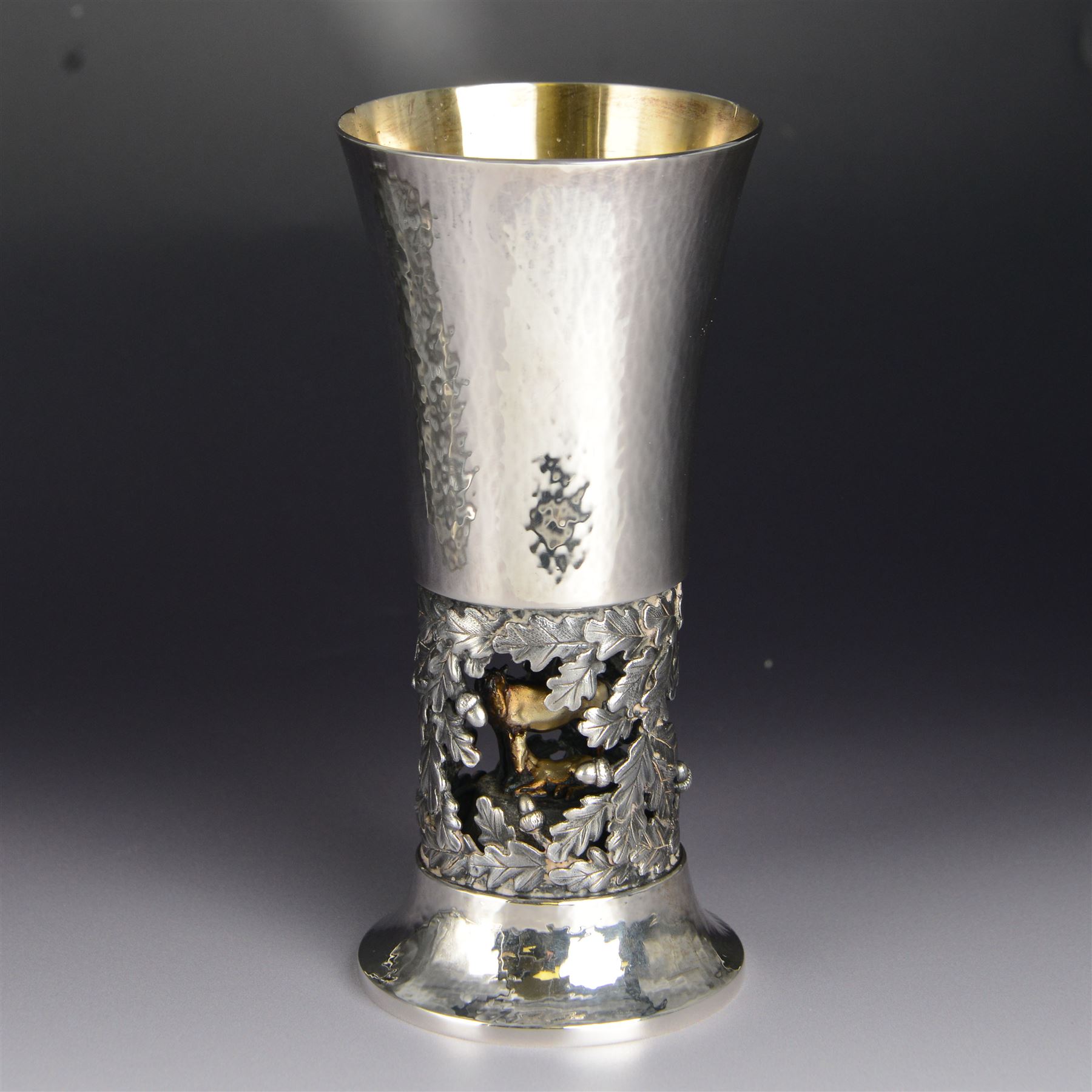 Modern limited edition silver goblet, 'by order of The New Forest of Ninth Centenary Trust this goblet has been produced to mark the 900th anniversary of the Forest in 1979' designed by Hector Miller for Aurum, the fluted planished bowl with gilt interior, upon a stem decorated in relief with oak leaves and acorns revealing a harse and foal to centre, limited edition no. 375, hallmarked Hector Miller, London 1980, H16.5cm, boxed