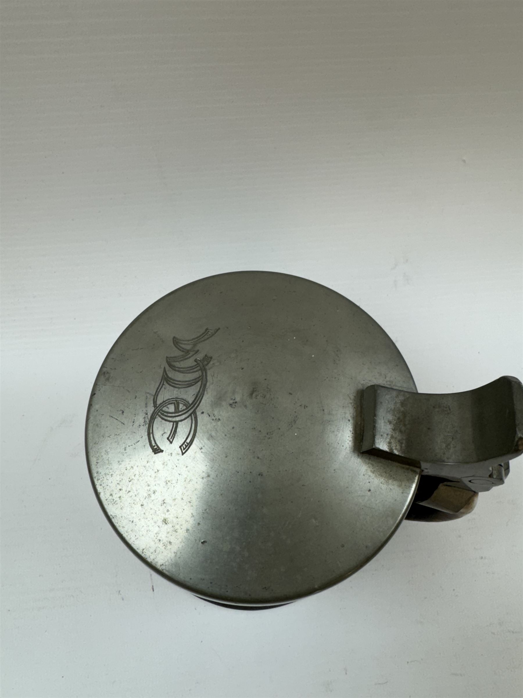 Arts and Crafts or Jugendstil tankard by Richard Riemerschmid, circa 1906, the cylindrical stoneware body reading 'Gaudeamus Igitur' (therefore let us rejoice), and finished in a brown glaze, with engraved slightly domed hinged lid, impressed mark beneath for Reinhold Merkelbach Grenzhausen, model number 2026 W, H14.5cm 