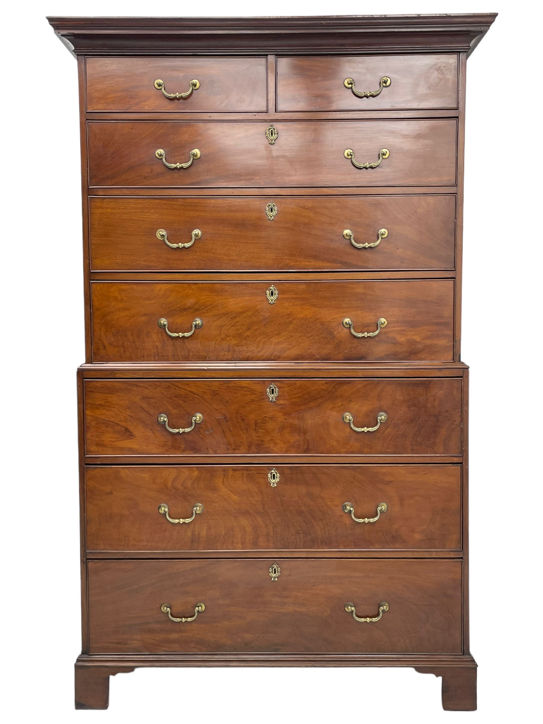 George III figured mahogany chest-on-chest, projecting moulded cornice over two short and six long graduating cock-beaded drawers, on bracket feet