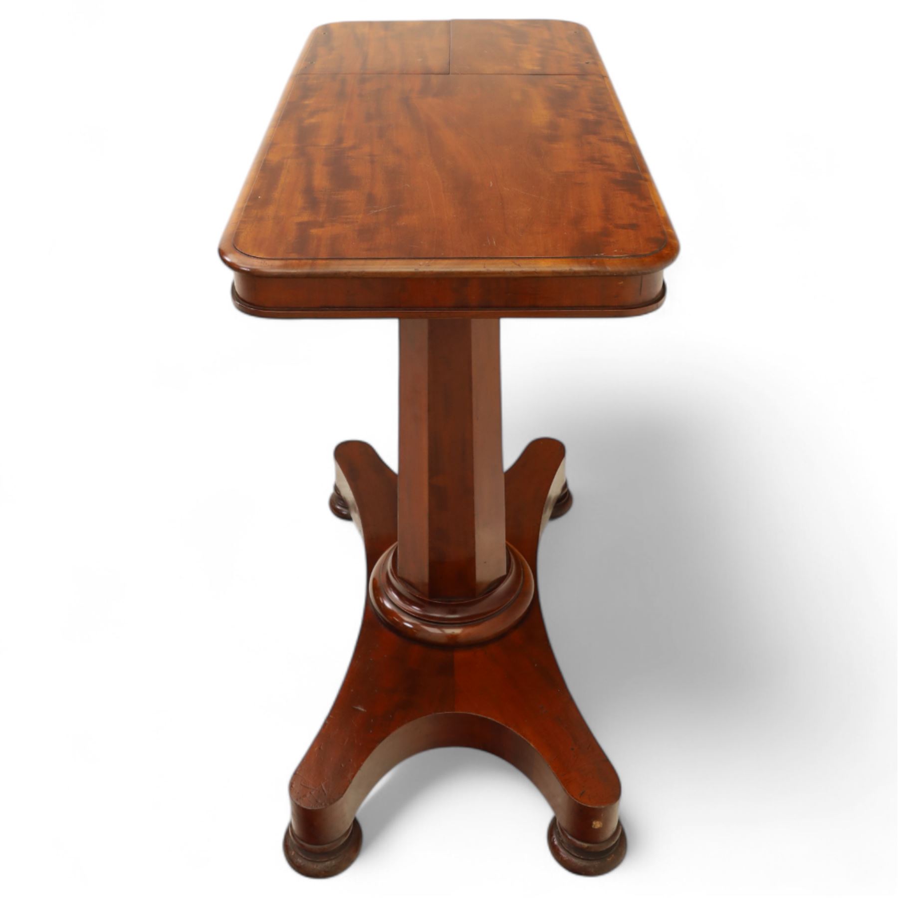 William IV mahogany reading table, the rectangular top with rounded corners and moulded edge, one end fitted with two hinged adjustable reading slops with two rests, the sliding top with a sprung stay mechanism, supported on a single tapered faceted column  with turned collar on a quatreform base with compressed bun feet