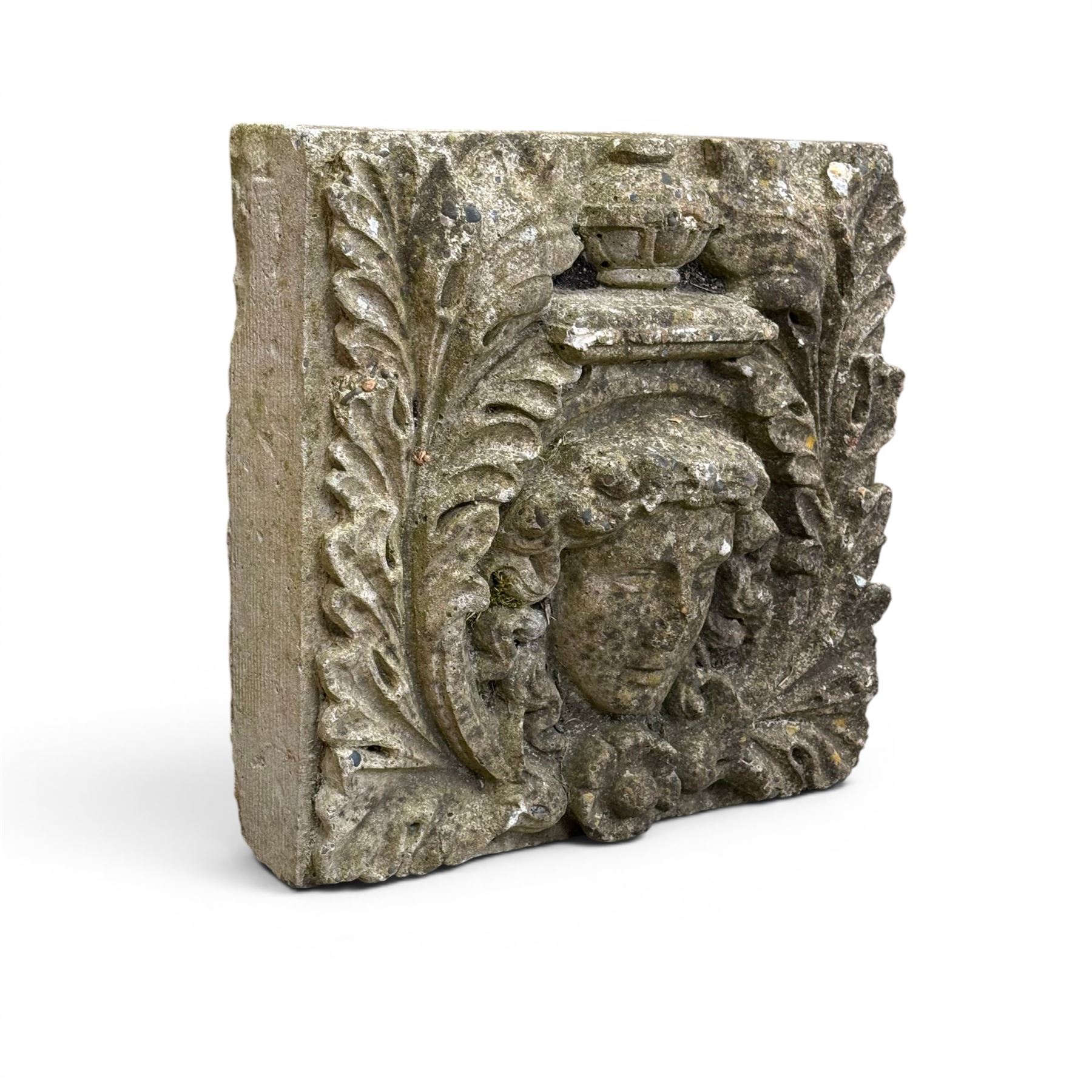 Weathered cast stone decorative wall panel, central female mask with urn motif surrounded by foliage