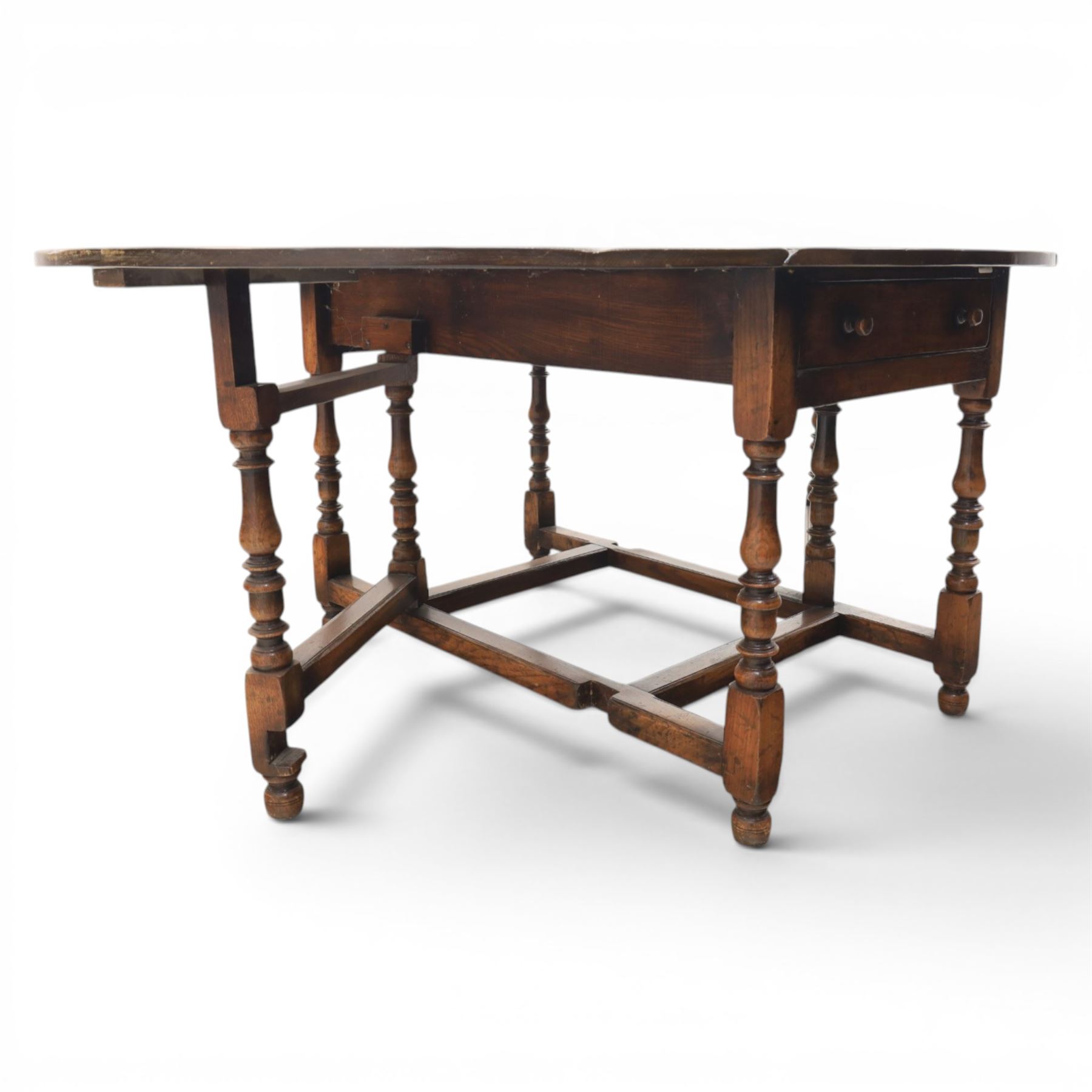 Titchmarsh & Goodwin - 18th century design oak oval drop-leaf dining table with leather dining chairs, the table with drop leaves forming an oval top extending to 180cm, with drawer to either side, raised on turned supports with gateleg, the chairs comprising two carvers in tan leather and two side chairs in green and tan leather backs, brass studded trim with turned uprights and stretchers