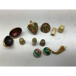 Collection of early 20th century and later thimble holders, to include a coquilla nut example, a floral decorated examples etc together with parquetry wooden tape measure 